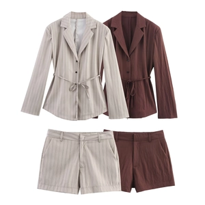 Flat lay of women's pinstripe and solid blazer sets with matching shorts and belts