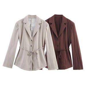 Detail of striped grey and coffee brown blazers featuring waist ties and classic lapels