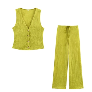 Detail of lime green textured vest and drawstring wide-leg pants showing fabric texture