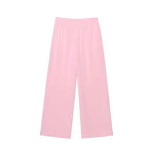 Detail of light pink high-waist wide-leg trousers with elastic waistband and soft drape