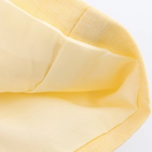 Minimalist yellow blazer with large pockets, macro view of high-quality fabric texture
