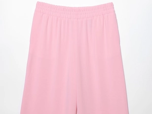 Detail view of pink wide-leg pants with comfortable elastic high waist and soft texture
