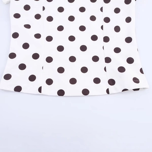 Chic white strapless top with black polka dots featuring premium stitching details