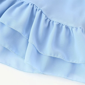 Detail of layered baby blue chiffon ruffles and fine hem stitching on the dress skirt
