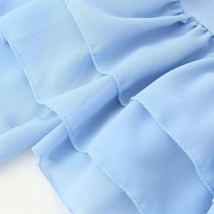 Close-up of light blue chiffon dress featuring delicate layered ruffles and breathable fabric