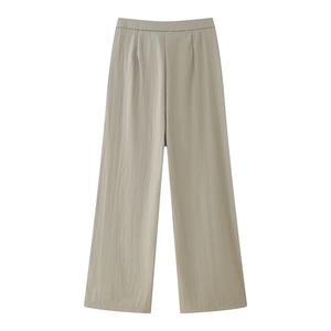 Détail du pantalon large beige à taille haute avec plis frontaux et tissu fluide