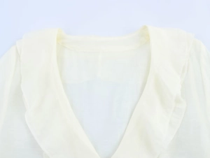 Detail of V-neckline with double-layered ruffles on cream chiffon blouse for women