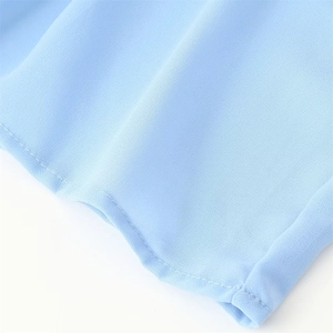 Close-up of light blue chiffon dress fabric showing fine texture and neat stitching details