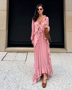 Close-up of layered ruffle hem and flowing chiffon fabric on a pale pink maxi dress