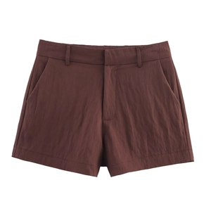 Detail view of coffee brown shorts featuring pleated texture, belt loops, and side pockets