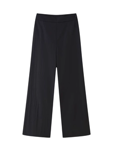 Détail d'un pantalon large noir à taille haute avec tissu tissé lisse et fermeture éclair cachée