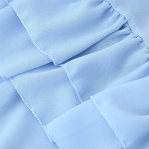 Detail shot of light blue pleated fabric texture with fine stitching on dress
