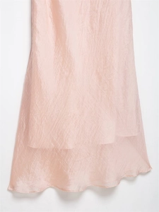 Detail of light pink crinkled fabric with a sheer texture and subtle gloss finish
