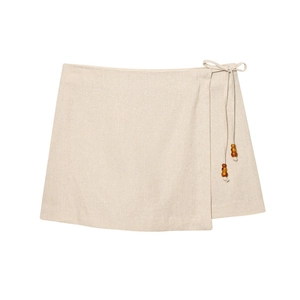 Linen wrap mini skirt with side tie and amber bead accents in natural beige