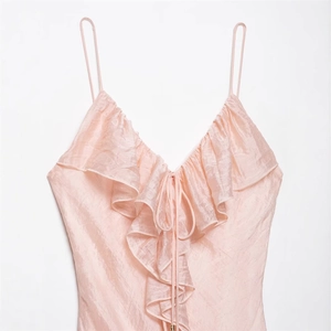 Elegant light pink satin V-neck camisole with ruffled trim and delicate tie-up detail