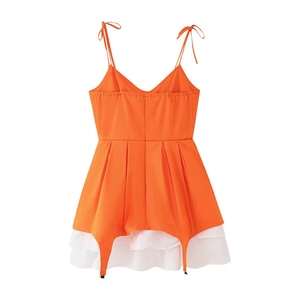 Detail view of the lace-up straps and back invisible zipper on the orange mini dress
