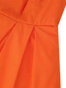 Macro view showing detailed waist pleats on bright orange layered mini dress fabric