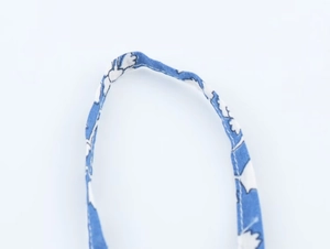 Detailed close-up of royal blue floral print strap with precision white stitching