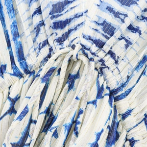 Close-up of tie-dye waist with drawstring and metallic Lurex threads on a V-neck dress
