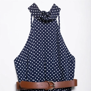 Abito a pois blu navy con scollo all'americana e cintura in ecopelle marrone su bianco