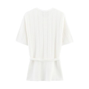 Detailed macro view of white pointelle knit fabric pattern and ribbed texture on the hem