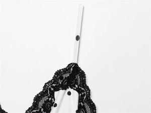 Close-up of French vintage polka dot dress featuring delicate black floral lace trim