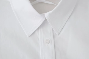 Close-up of white shirt collar with neat stitching and back cross-tie detail