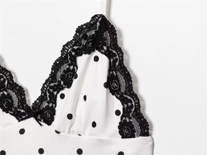 Detail of French vintage polka dot dress with black lace V-neck and ribbon bow
