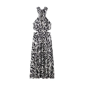 Detail view of the halter neckline and cutout waist on the black and white floral dress