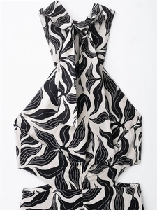 Detail of linen blend halter top with black and white leaf print and side cut-outs