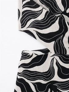 Detail of linen blend fabric with black and white abstract print and cutout tailoring