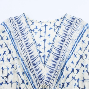 Blue and white tie-dye V-neck dress with metallic thread stripes for early spring fashion