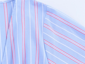 Detail of blue striped cotton fabric showing premium shoulder stitching and texture