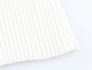 Macro shot of the white ribbed knit fabric texture showing high elasticity on the sleeve cuff