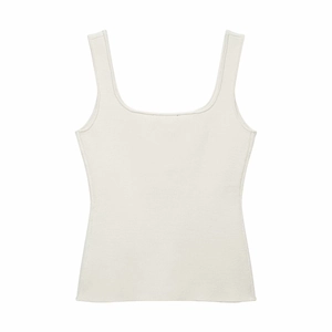 Detailed close-up of ivory white ribbed knit camisole top featuring thick shoulder straps