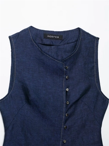 Detail of dark blue linen vest featuring side silver metal buttons and round neckline