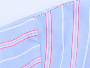 Detailed macro view of high-quality sewing and stripe alignment on short sleeve loungewear