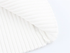 Detailed close-up of pure white rib knit fabric showing high-elasticity texture