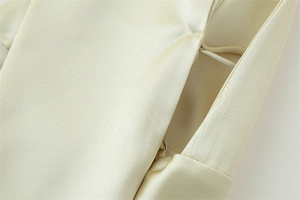 Detail view of smooth champagne satin dress with neat invisible zipper stitching