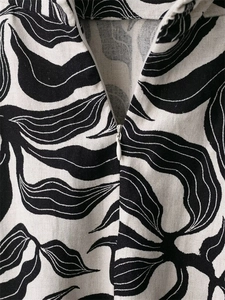 Detail view of linen blend fabric with black and white abstract print and hidden zipper