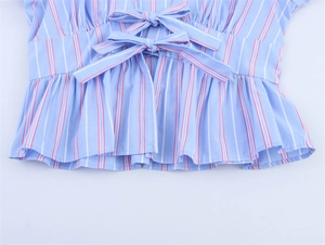 Close-up of blue striped top with delicate bow ties and ruffled hem detailing