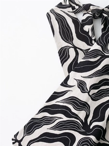 Detail of halter neck tie and black leaf print on breathable linen-blend fabric