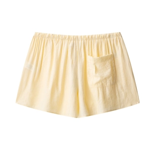 Detail of pale yellow crinkle texture shorts featuring elastic waist and back pocket