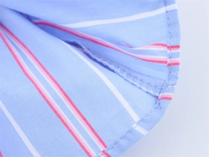 Close-up of light blue striped fabric showing high-quality stitching and seam details