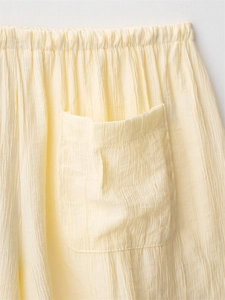 Detail of cream yellow crinkle fabric set showing elastic waist and rectangular pocket