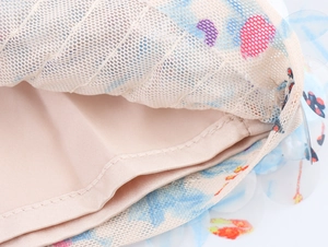 Detailed macro view of sheer mesh fabric with heart prints and sequins on a knit skirt