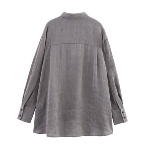 Detail view of the back yoke and box pleat on a striped oversized linen blend shirt