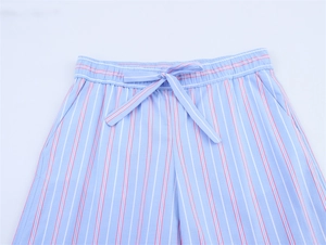 Detailed view of elastic waistband with drawstring on blue striped cotton casual pants