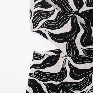 Linen blend halter maxi dress with black and white abstract leaf print and waist cutout