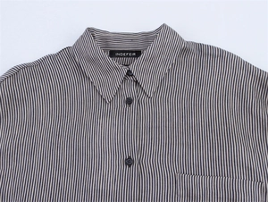 Close-up of linen-blend striped shirt featuring flat collar, chest pocket, and blue vertical lines